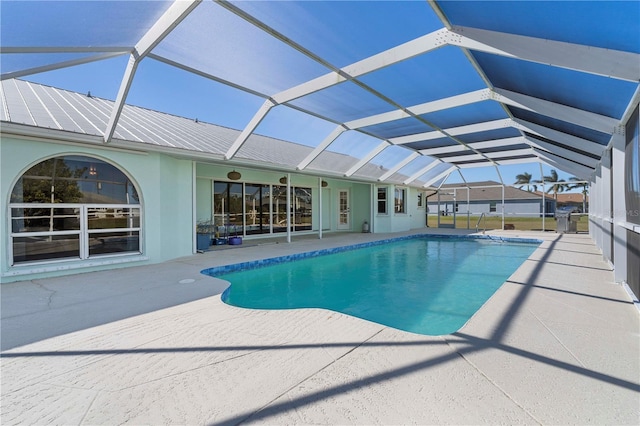 view of pool with a patio area and a lanai