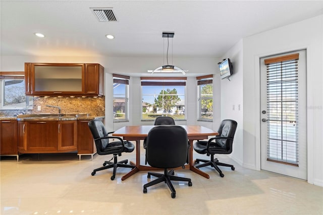 tiled dining area with a wealth of natural light and sink