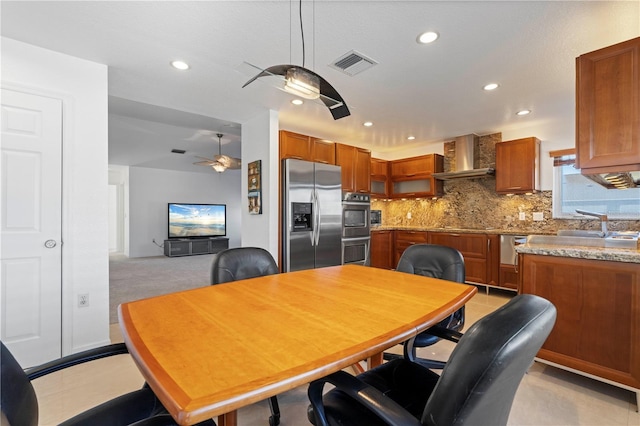 tiled dining area featuring ceiling fan and sink