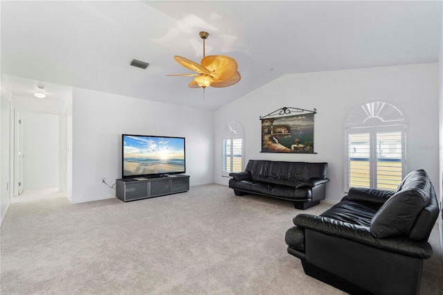 living room with ceiling fan, a healthy amount of sunlight, light colored carpet, and lofted ceiling