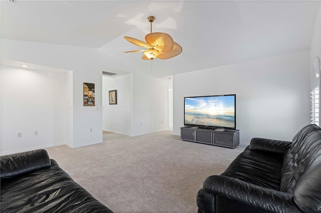 carpeted living room featuring ceiling fan and vaulted ceiling