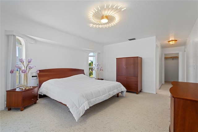 bedroom with a walk in closet and a closet