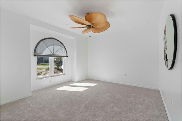 unfurnished room featuring light colored carpet and ceiling fan