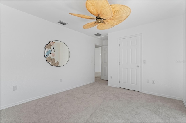 unfurnished bedroom featuring ceiling fan and light carpet