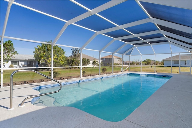 view of pool with a patio, a lanai, and a lawn