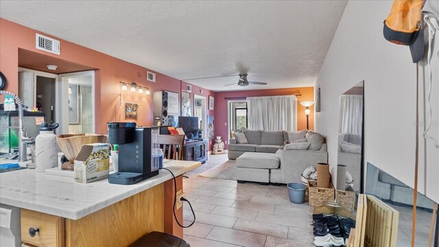26485 Rampart Blvd Unit E7, Punta Gorda, FL 33983 - kitchen featuring a ceiling fan, light countertops, light tile patterned flooring, and open floor plan