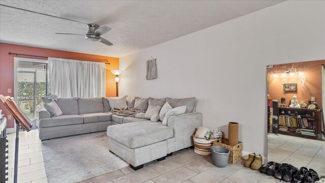 26485 Rampart Blvd Unit E7, Punta Gorda, FL 33983 - living room featuring ceiling fan, light tile patterned floors, and a textured ceiling