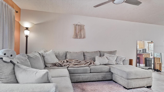 tiled living room featuring a textured ceiling and ceiling fan