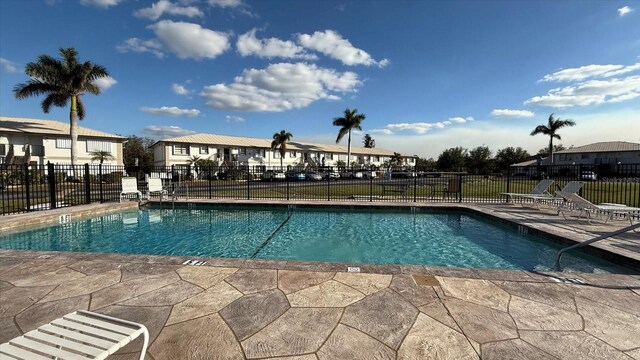 26485 Rampart Blvd Unit E7, Punta Gorda, FL 33983 - community pool featuring a patio and a residential view