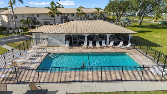 view of swimming pool with a lawn and a patio area