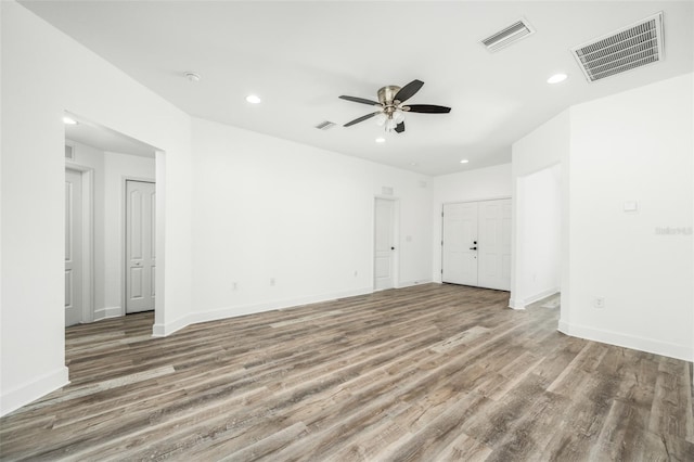 unfurnished room featuring ceiling fan and hardwood / wood-style flooring