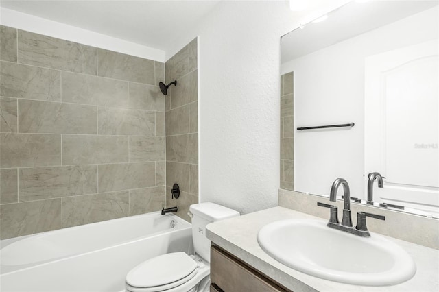 full bathroom with tiled shower / bath combo, toilet, and vanity