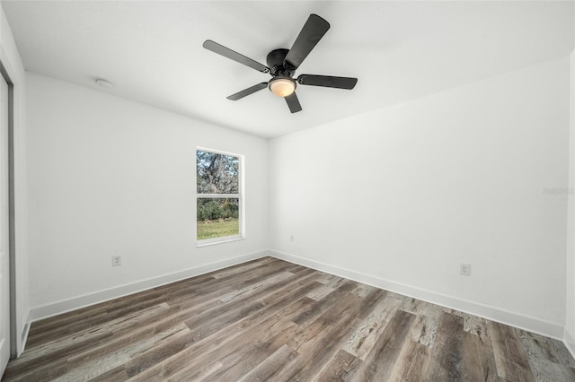 unfurnished room with ceiling fan and dark hardwood / wood-style floors