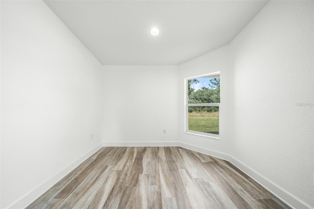 unfurnished room with light wood-type flooring