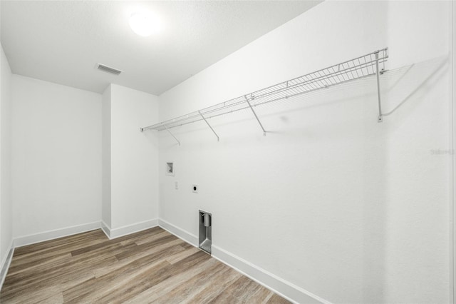 laundry area featuring hookup for an electric dryer, wood-type flooring, and washer hookup