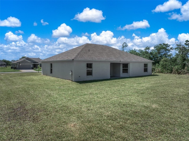 rear view of property with a lawn