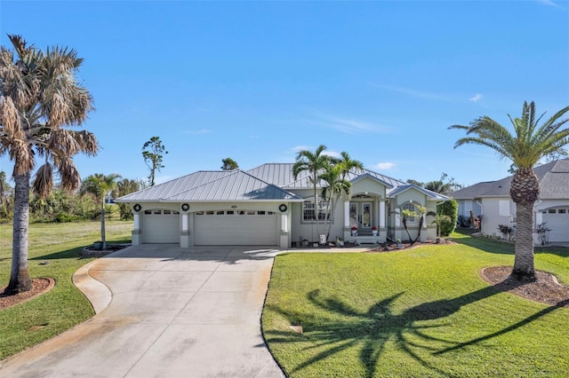 view of front of property with a front yard and a garage