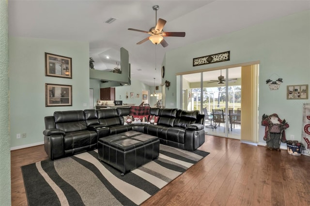 living room with ceiling fan, dark hardwood / wood-style flooring, and lofted ceiling