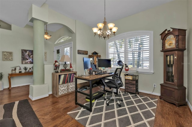 home office with a chandelier, decorative columns, vaulted ceiling, and dark wood-type flooring