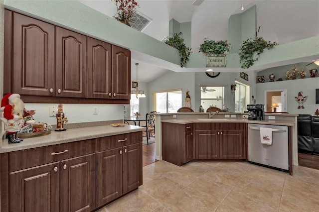 kitchen with dark brown cabinetry, dishwasher, sink, hanging light fixtures, and high vaulted ceiling