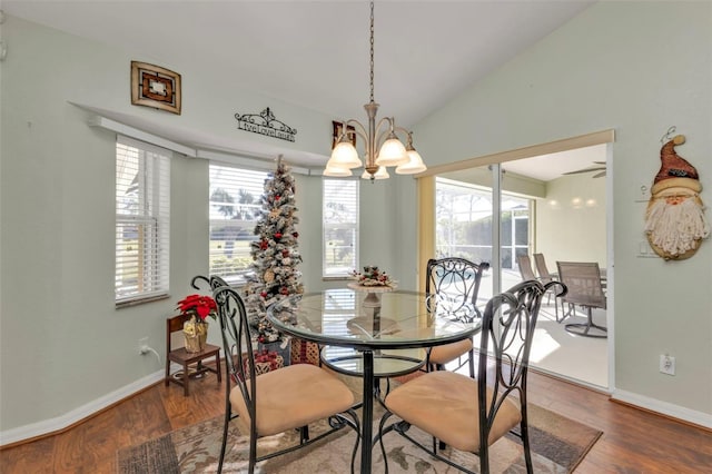 dining area featuring plenty of natural light, wood-type flooring, ceiling fan with notable chandelier, and lofted ceiling