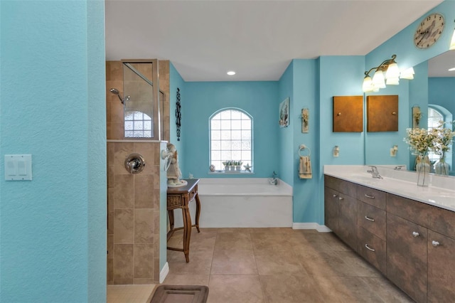 bathroom with tile patterned flooring, vanity, and independent shower and bath