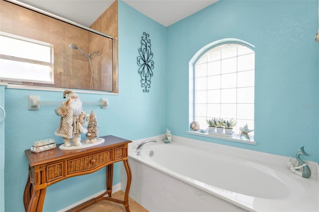 bathroom with tile patterned floors, a healthy amount of sunlight, and shower with separate bathtub