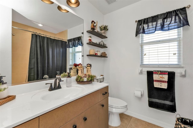 bathroom featuring tile patterned floors, curtained shower, vanity, and toilet