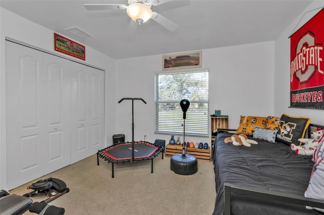 bedroom featuring ceiling fan, a closet, and carpet