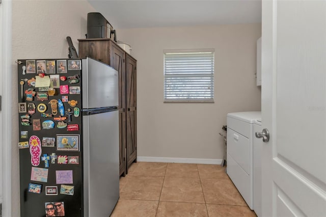 kitchen with light tile patterned flooring, separate washer and dryer, and stainless steel refrigerator