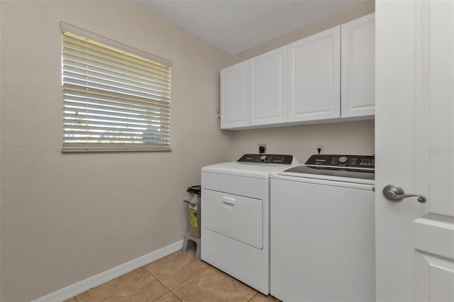 laundry room featuring cabinets, independent washer and dryer, and light tile patterned flooring