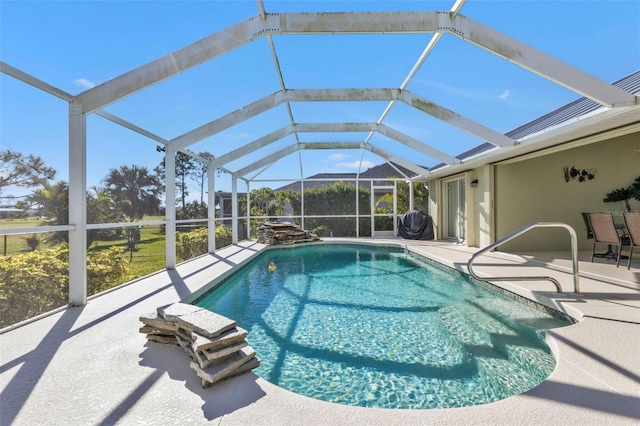 view of pool with a patio area and a lanai