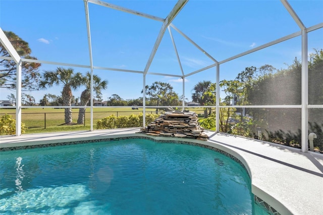 view of swimming pool featuring a lanai