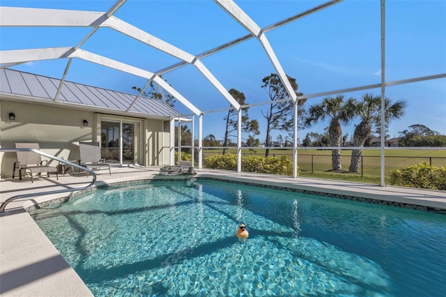 view of swimming pool featuring a patio and a lanai