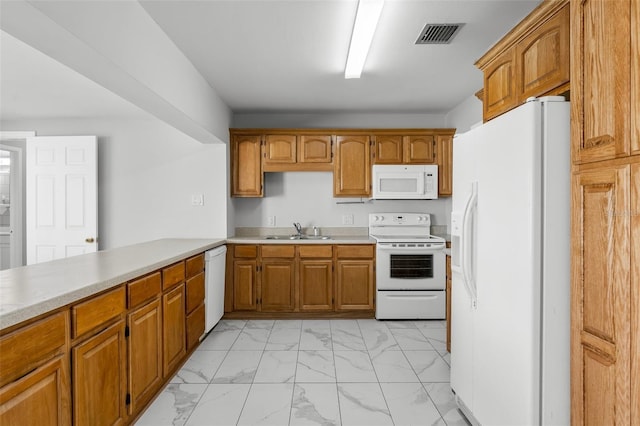 kitchen featuring kitchen peninsula, white appliances, and sink