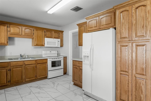 kitchen featuring white appliances and sink