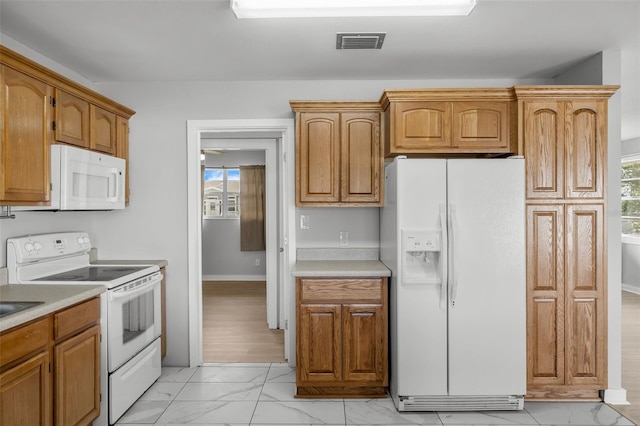 kitchen with white appliances and a wealth of natural light