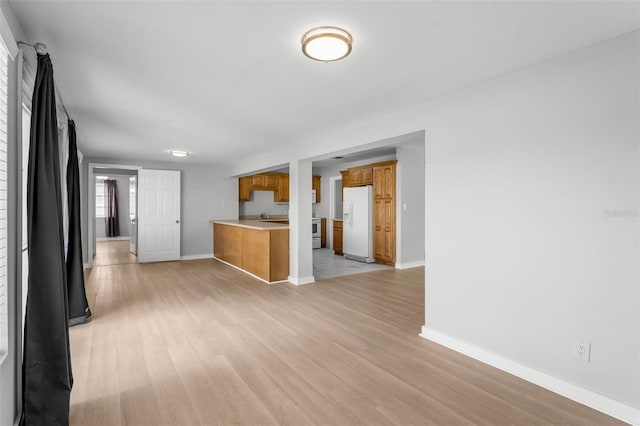 unfurnished living room with light wood-type flooring