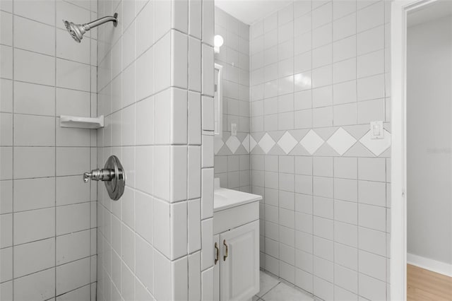 bathroom featuring vanity and a tile shower