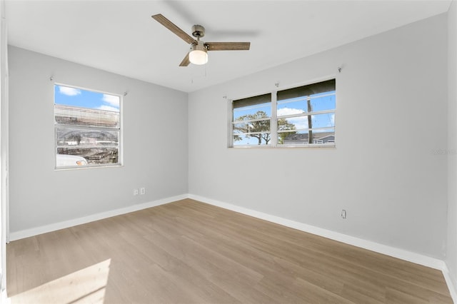 spare room featuring light wood-type flooring and ceiling fan