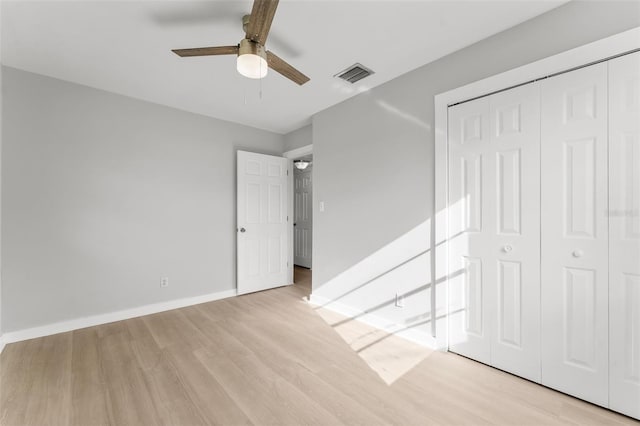 unfurnished bedroom with ceiling fan, a closet, and light hardwood / wood-style flooring