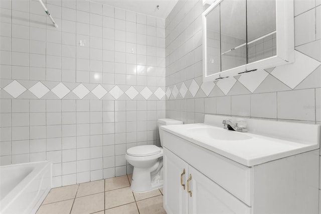 bathroom featuring tile patterned floors, vanity, toilet, and tile walls