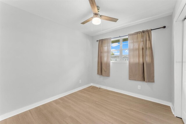 spare room with light hardwood / wood-style flooring and ceiling fan