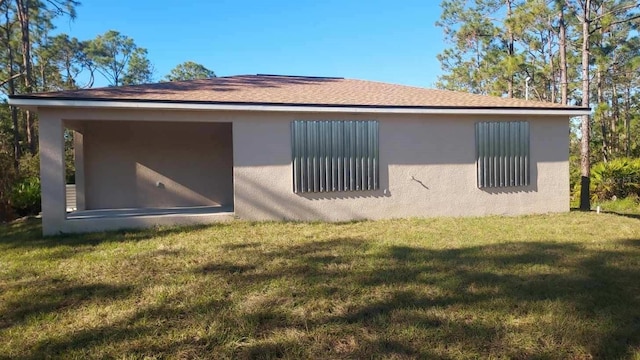 rear view of house featuring a lawn