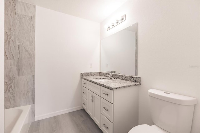 full bathroom with hardwood / wood-style floors, vanity, shower / bathtub combination, and toilet