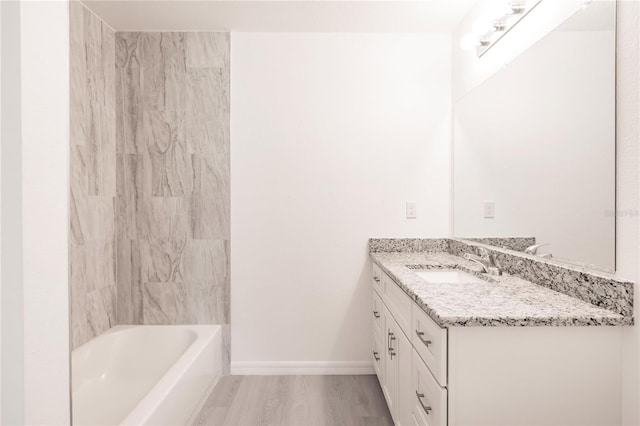 bathroom featuring vanity, wood-type flooring, and tub / shower combination