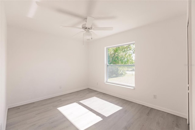 empty room with light hardwood / wood-style floors and ceiling fan