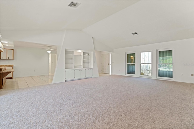 unfurnished living room featuring ceiling fan, built in features, light carpet, and lofted ceiling