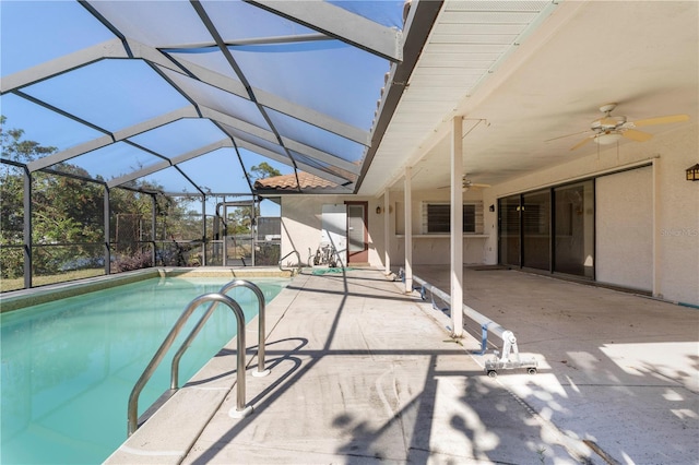 view of swimming pool featuring a patio area, ceiling fan, and a lanai