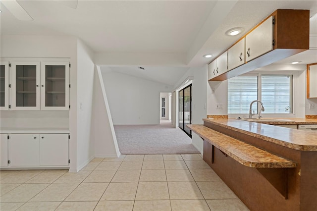 kitchen featuring white cabinetry, light tile patterned floors, and a healthy amount of sunlight